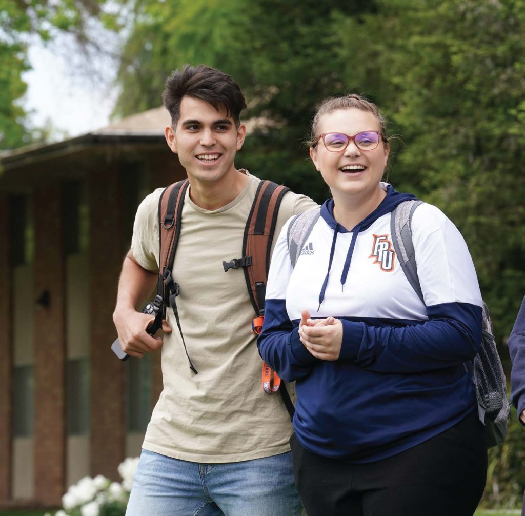 Two FPU students smiling and walking